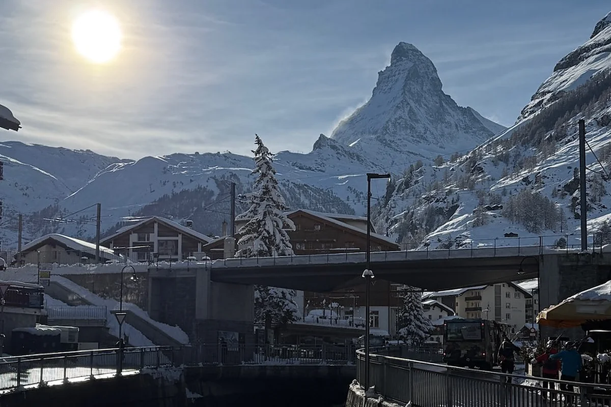 Zermatt village with the Matterhorn rising above, late afternoon light over the Vispa river.
